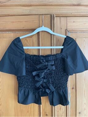 Anthropologie Black Smocked Peplum Top with Bow Detail